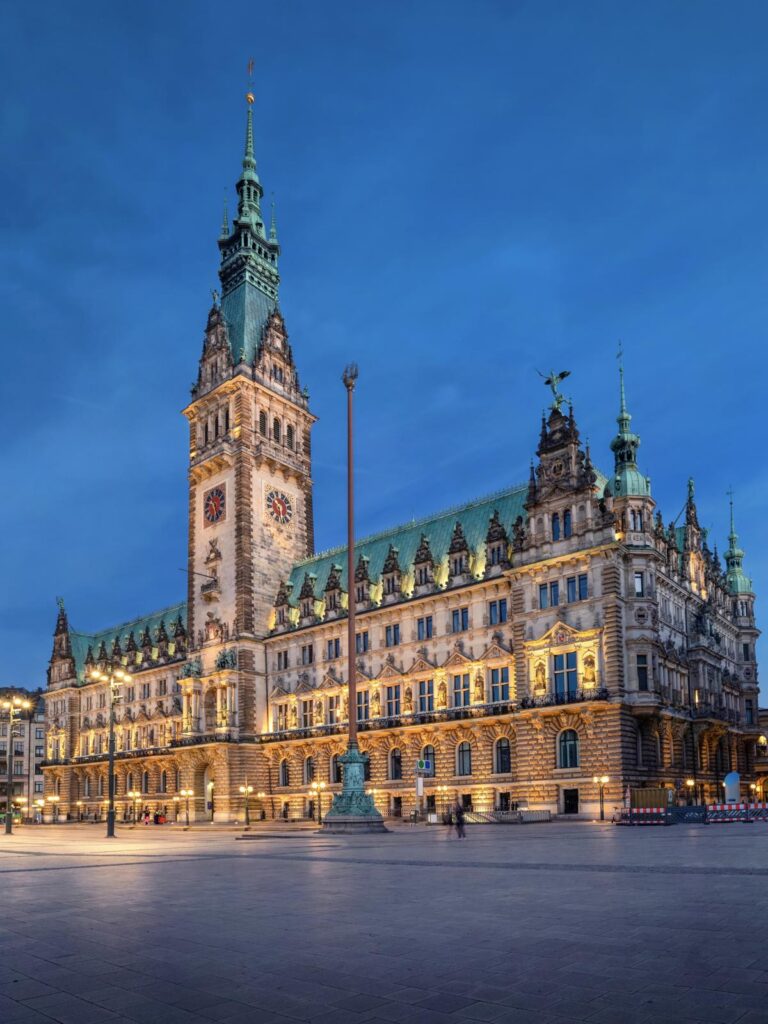 Hamburg, Germany. View of illuminated Town Hall building at dusk located on Rathausmarkt square